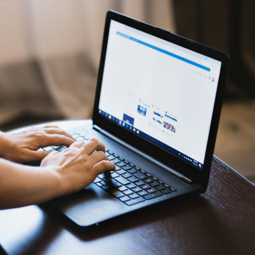 typing at a laptop
